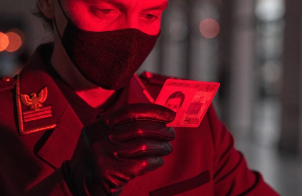 A government official inspecting a secure ID card