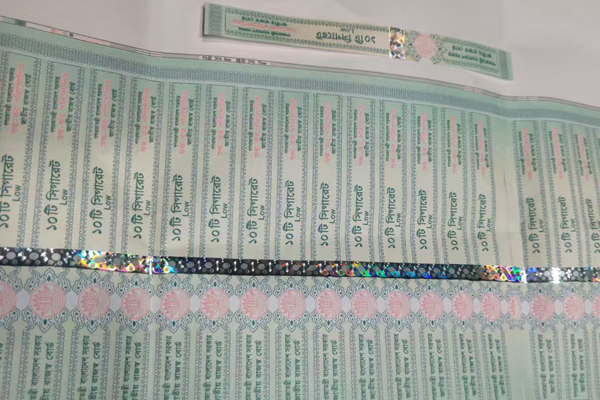 A close-up of a bright, multi-dimensional hologram on a tax stamp