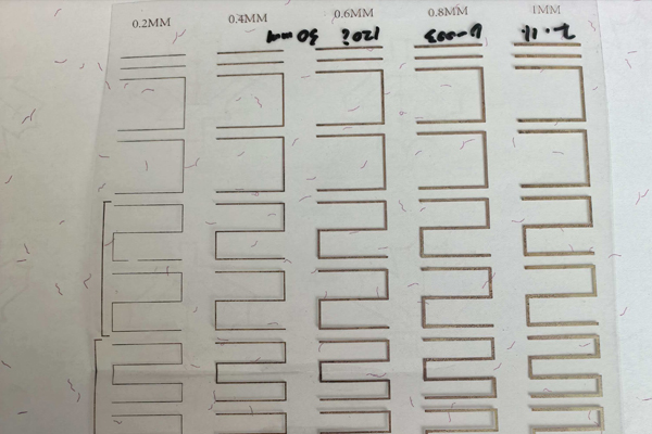 An illustration showing a handheld device scanning a certificate with conductive ink circuits.