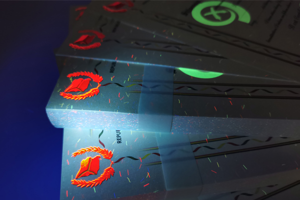 Comparison of visible, invisible, and dual-mode UV ink on a certificate