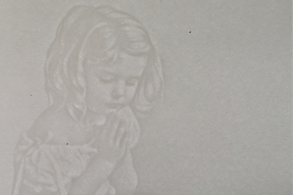 An official holding a certificate up to a window to check the watermark