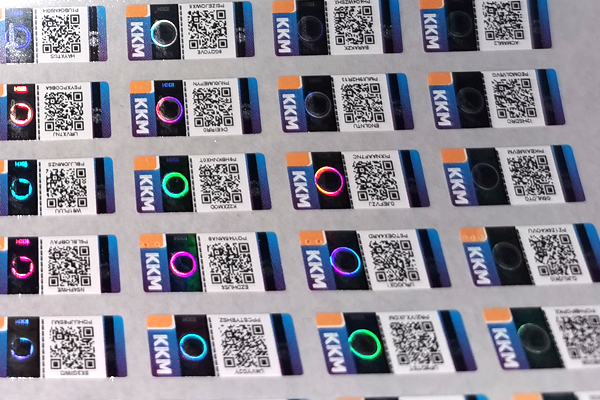 A smartphone scanning a QR code on a tax stamp for verification