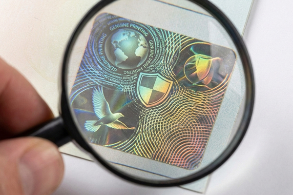 A close-up of a holographic security label with microtext.