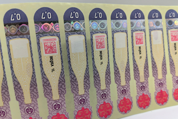 A close-up of a secure tax stamp with holographic features